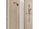 Modern shower featuring marble tiles and a shower head at 811 Laguna Dr, Venice, FL 34285