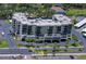 Aerial view of a light beige condominium complex, highlighting the building's architecture and well-maintained surroundings at 9860 62Nd N Ter # 1047, St Petersburg, FL 33708