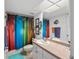 Bright bathroom showcases decorative shower curtain, vanity with a large mirror and ample lighting at 9860 62Nd N Ter # 1047, St Petersburg, FL 33708