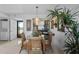 Cozy dining area features a glass table, tropical decor, and a view from the patio at 9860 62Nd N Ter # 1047, St Petersburg, FL 33708