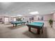 Billiards room featuring two pool tables, comfortable seating, and warm decor at 9860 62Nd N Ter # 1047, St Petersburg, FL 33708
