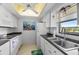 The kitchen features white appliances, dark countertops, and a window that provides natural light and ventilation at 9860 62Nd N Ter # 1047, St Petersburg, FL 33708