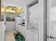 Convenient in-unit laundry closet featuring a stacked washer and dryer at 9860 62Nd N Ter # 1047, St Petersburg, FL 33708