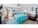 Bright bedroom with a blue comforter, modern decor, and ample natural light, creating a welcoming atmosphere at 9860 62Nd N Ter # 1047, St Petersburg, FL 33708