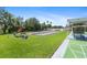 Community shuffleboard courts with picnic tables under a red umbrella and green landscaping at 9860 62Nd N Ter # 1047, St Petersburg, FL 33708