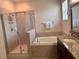 Spacious bathroom with separate shower and soaking tub, plus granite vanity top at 13642 Newport Shores Dr, Hudson, FL 34669