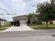 Charming single Gathering home features a well-maintained lawn and a two-car garage at 13642 Newport Shores Dr, Hudson, FL 34669