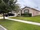 Well-manicured lawn accents the home's exterior, featuring a two-car garage at 13642 Newport Shores Dr, Hudson, FL 34669