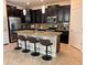Eat-in kitchen featuring a large island, granite counters, stainless appliances, and dark cabinetry at 13642 Newport Shores Dr, Hudson, FL 34669