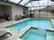 Enclosed pool features an attached jacuzzi, chairs for lounging, and privacy fence at 13642 Newport Shores Dr, Hudson, FL 34669