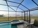 View of the enclosed pool and attached jacuzzi overlooking a peaceful lake view at 13642 Newport Shores Dr, Hudson, FL 34669