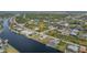 Aerial view of a waterfront home with canal access, in a lush neighborhood at 15340 Alsask Cir, Port Charlotte, FL 33981