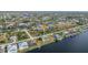 Aerial view of a home located on a canal with established landscaping and community at 15340 Alsask Cir, Port Charlotte, FL 33981