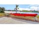 Backyard waterway access with red kayak for water enthusiasts and waterfront enjoyment at 15340 Alsask Cir, Port Charlotte, FL 33981