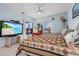 Bright bedroom with two beds, ceiling fan, and sliding door to outdoor view at 15340 Alsask Cir, Port Charlotte, FL 33981