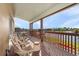 Covered deck with wicker chairs overlooking the water provides a relaxing outdoor living space at 15340 Alsask Cir, Port Charlotte, FL 33981