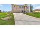 Well-maintained home with a manicured lawn, driveway, and two-car garage at 15340 Alsask Cir, Port Charlotte, FL 33981