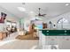 Open-concept living room with neutral decor, tile floors and sliding door to patio at 15340 Alsask Cir, Port Charlotte, FL 33981