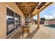 Covered patio area with outdoor seating overlooking the pool and backyard at 15340 Alsask Cir, Port Charlotte, FL 33981