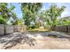 Expansive backyard featuring a concrete patio, lush trees, and a privacy fence, ideal for outdoor enjoyment at 1769 Dayton S St, St Petersburg, FL 33712