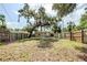Beautiful backyard with mature trees, a privacy fence, and ample space for recreation and outdoor activities at 1769 Dayton S St, St Petersburg, FL 33712