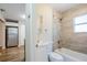 Bathroom with tub-shower combination, a modern toilet, and white fixtures, located just off the kitchen at 1769 Dayton S St, St Petersburg, FL 33712