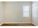 Vacant bedroom displays wood-look floors, a window with blinds, and a white door at 1769 Dayton S St, St Petersburg, FL 33712