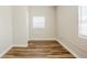 Unfurnished bedroom exhibiting wood-look floors, window with blinds, and minimalist design at 1769 Dayton S St, St Petersburg, FL 33712
