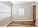Bright bedroom featuring wood-look floors and white trim with ample natural light at 1769 Dayton S St, St Petersburg, FL 33712
