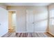 A spacious bedroom with new flooring, neutral walls, and multiple doors, allowing flexible use at 1769 Dayton S St, St Petersburg, FL 33712