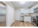Modern kitchen with stainless steel appliances, white cabinets, and sleek countertops at 1769 Dayton S St, St Petersburg, FL 33712