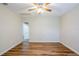 Spacious living room featuring wood-look floors, white trim, and ceiling fan at 1769 Dayton S St, St Petersburg, FL 33712