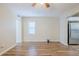 Spacious living room featuring wood-look floors, white trim, ceiling fan and connecting to kitchen at 1769 Dayton S St, St Petersburg, FL 33712