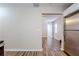 Open-concept living area with light walls and wood-look vinyl flooring, seamlessly connected to the kitchen at 1769 Dayton S St, St Petersburg, FL 33712