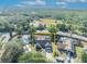 An aerial shot highlights a home with ample yard space near a road and wooded area, outlined in yellow at 2601 Bridle Dr, Plant City, FL 33566