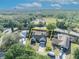 Aerial view of a lovely home surrounded by a well-manicured lawn and mature trees, outlined in yellow at 2601 Bridle Dr, Plant City, FL 33566