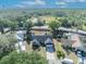 An aerial view reveals a charming home with a well-kept lawn and a serene, wooded backdrop at 2601 Bridle Dr, Plant City, FL 33566