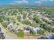 An aerial view showcases a home nestled in a lush, green neighborhood near a tranquil lake at 2601 Bridle Dr, Plant City, FL 33566