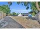 Vast backyard enclosed by a wooden fence and mature trees, offering privacy and space for outdoor enjoyment at 2601 Bridle Dr, Plant City, FL 33566