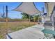 Spacious backyard patio with shade canopies and grill, perfect for outdoor entertaining and relaxation at 2601 Bridle Dr, Plant City, FL 33566