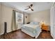 Bedroom features a ceiling fan, wood floors, and a light blue comforter at 2601 Bridle Dr, Plant City, FL 33566