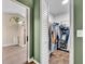 A peek into the walk-in closet and bathroom, featuring a shower and tile floors at 2601 Bridle Dr, Plant City, FL 33566