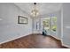 Bright dining room with hardwood floors, a bay window, and modern chandelier lighting at 2601 Bridle Dr, Plant City, FL 33566