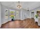 Elegant dining room with hardwood floors, a bay window, and modern chandelier lighting at 2601 Bridle Dr, Plant City, FL 33566