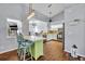 An open kitchen area featuring a view of the dining area, stainless steel appliances, and a green accent island at 2601 Bridle Dr, Plant City, FL 33566