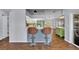 Eat-in kitchen featuring a breakfast bar, stainless steel appliances, and hardwood style flooring at 2601 Bridle Dr, Plant City, FL 33566