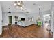 Open-concept living room with vaulted ceilings, modern lighting and hardwood style flooring throughout at 2601 Bridle Dr, Plant City, FL 33566