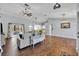 Open-concept living room featuring wood floors, high ceilings, modern lighting, and a comfortable couch at 2601 Bridle Dr, Plant City, FL 33566