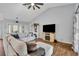 Comfortable living room with vaulted ceiling, stylish furniture, and a decorative fireplace at 2601 Bridle Dr, Plant City, FL 33566