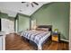 Bedroom features vaulted ceilings, wood floors, a ceiling fan, and access to a walk-in closet at 2601 Bridle Dr, Plant City, FL 33566